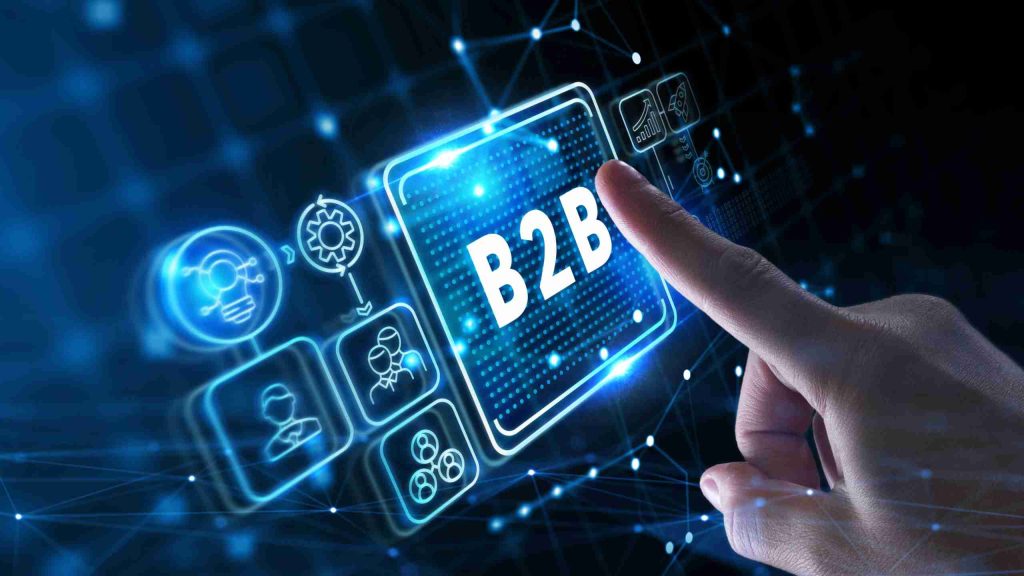 Mão toca ícone digital com a sigla B2B em interface tecnológica azul.